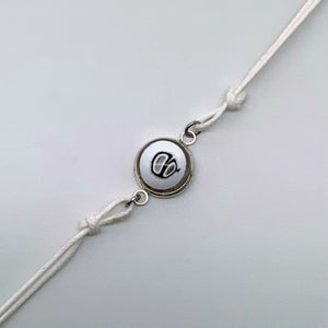 White bracelets with a mix of glass centers