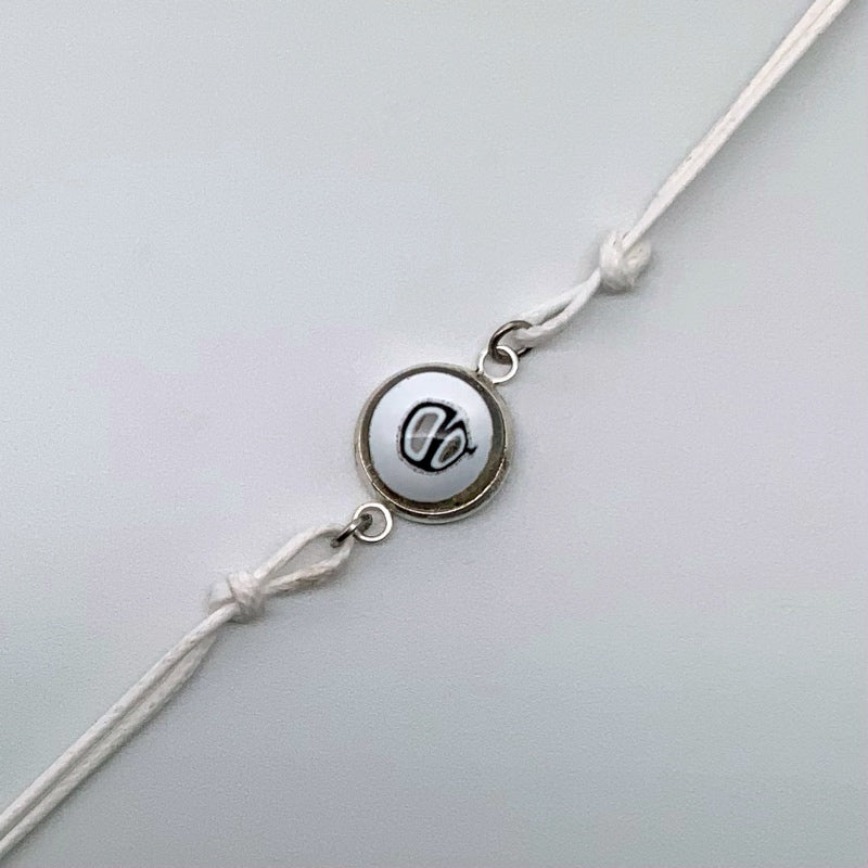 White bracelets with a mix of glass centers