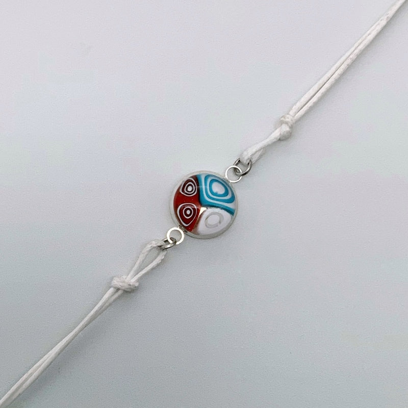 White bracelets with a mix of glass centers