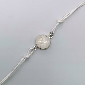 White bracelets with a mix of glass centers