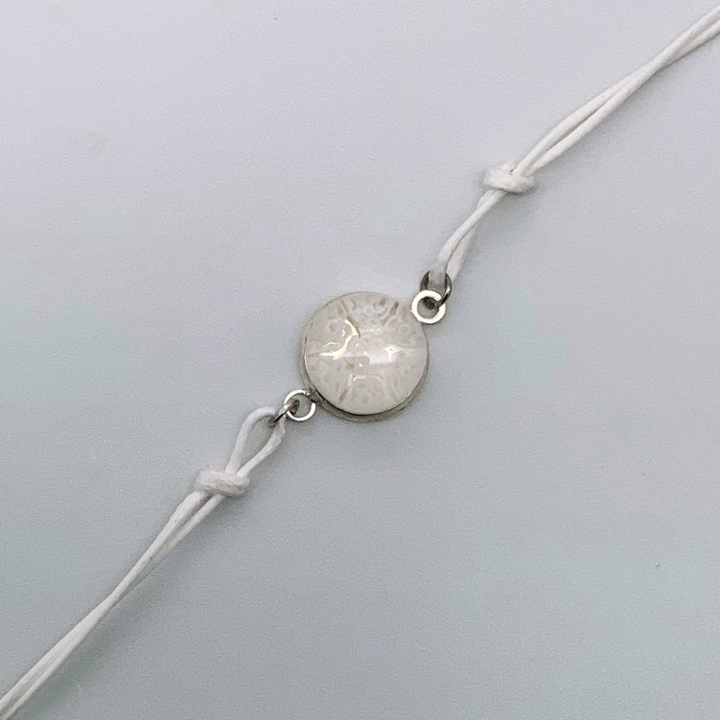 White bracelets with a mix of glass centers