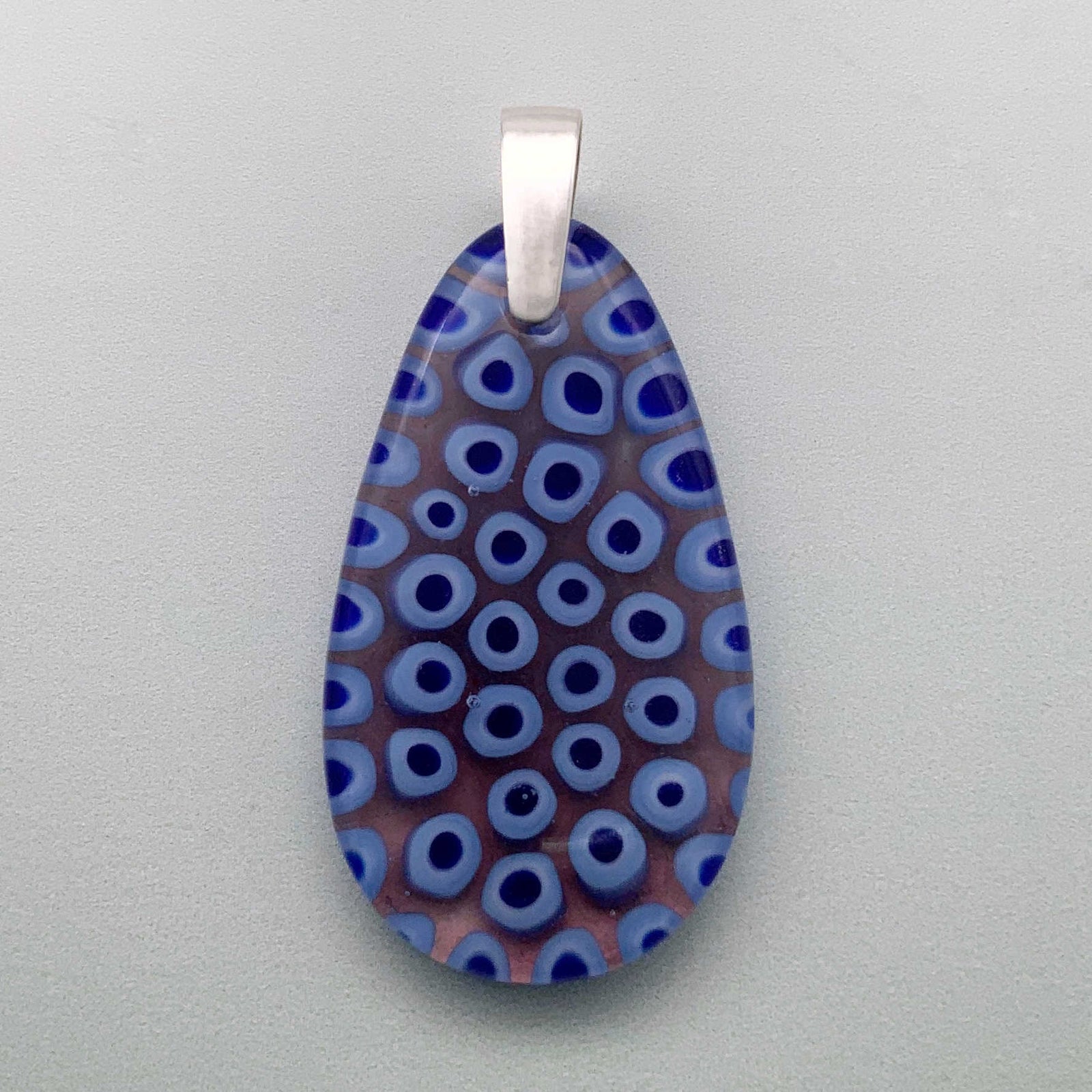 Blue caviar glass drop pendant with a  plum undertone